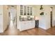 A bar area with custom cabinetry, glass shelving, a wine fridge, and granite countertops at 4225 Maner Se St, Smyrna, GA 30080