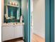 Stylish powder room with a vessel sink, modern fixtures, and teal accents at 4225 Maner Se St, Smyrna, GA 30080