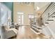 Sunlit entryway with a modern staircase featuring stylish railings and light wood floors at 4225 Maner Se St, Smyrna, GA 30080