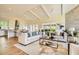 Inviting living room with vaulted ceilings, a stone accent wall, and open flow to the kitchen at 4225 Maner Se St, Smyrna, GA 30080