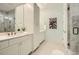 Elegant main bathroom with double sinks, white cabinets, and a glass-enclosed shower at 4225 Maner Se St, Smyrna, GA 30080
