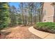 Landscaped backyard with trees and a walking trail at 7497 Treehouse Ct, Douglasville, GA 30135