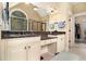 Well-appointed bathroom features dual sinks, granite countertops, tiled floors, and a walk-in closet at 7497 Treehouse Ct, Douglasville, GA 30135