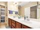 Bathroom featuring a double vanity, large mirror, and separate toilet and shower area at 7497 Treehouse Ct, Douglasville, GA 30135