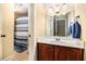 Cozy bathroom with a single vanity and tiled shower with a blue striped curtain at 7497 Treehouse Ct, Douglasville, GA 30135