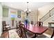 Spacious dining room with traditional decor, large windows, and elegant chandelier at 7497 Treehouse Ct, Douglasville, GA 30135