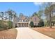 Charming home featuring a blend of brick and stone, manicured landscaping, and a spacious driveway at 7497 Treehouse Ct, Douglasville, GA 30135