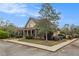 A covered porch adds curb appeal to this light yellow building set back from the street by mature landscaping at 7497 Treehouse Ct, Douglasville, GA 30135
