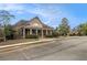 This amenity building with covered porch and classic curb appeal has ample parking for residents and visitors at 7497 Treehouse Ct, Douglasville, GA 30135