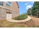 Charming home exterior features a brick foundation and winding sidewalk at 7497 Treehouse Ct, Douglasville, GA 30135