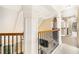 Upper hallway featuring grand columns, wood railings, and high ceilings at 7497 Treehouse Ct, Douglasville, GA 30135
