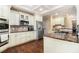 Bright kitchen showcasing stainless steel appliances, granite countertops, and white cabinets at 7497 Treehouse Ct, Douglasville, GA 30135