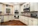 Well-equipped kitchen featuring double ovens, granite countertops, and ample cabinet space at 7497 Treehouse Ct, Douglasville, GA 30135