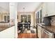 Dining room in a kitchen showing large windows for natural light and wood floors at 7497 Treehouse Ct, Douglasville, GA 30135