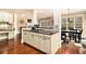 Kitchen island in an open floor plan, featuring granite countertops and stainless appliances at 7497 Treehouse Ct, Douglasville, GA 30135