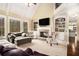 Open living room boasts a fireplace, vaulted ceilings, and many windows for natural light at 7497 Treehouse Ct, Douglasville, GA 30135