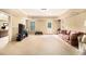 Large living room area with carpet, neutral walls, and walk out door at 7497 Treehouse Ct, Douglasville, GA 30135