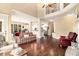 Bright living room featuring an open floor plan, wood floors, and large windows at 7497 Treehouse Ct, Douglasville, GA 30135