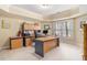 Well-lit home office featuring a large desk, neutral walls, and a window at 7497 Treehouse Ct, Douglasville, GA 30135