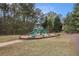 Community playground features slides and swings surrounded by lush greenery at 7497 Treehouse Ct, Douglasville, GA 30135