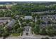 Aerial view of community with mature landscaping, roundabout, sidewalks, and common areas at 2630 Milford Ln, Alpharetta, GA 30009