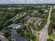 This aerial view of a community features townhouses, mature trees, a pool, and tennis courts at 2630 Milford Ln, Alpharetta, GA 30009