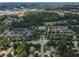 An aerial view of the community's townhouses with trees and a neighborhood in the background at 2630 Milford Ln, Alpharetta, GA 30009
