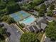 Aerial view of the community's tennis courts and pool, framed by trees and parking at 2630 Milford Ln, Alpharetta, GA 30009
