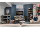 Finished basement with dark blue walls and multiple shelf units packed with toys and collectables at 2630 Milford Ln, Alpharetta, GA 30009