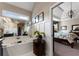 Elegant bathroom showcasing a tub and a glimpse into the bedroom with tray ceilings and decor at 2630 Milford Ln, Alpharetta, GA 30009