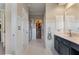 Clean bathroom with white tile, a vanity, and a view to a walk-in closet for optimal convenience at 2630 Milford Ln, Alpharetta, GA 30009
