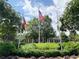 Academy Park clubhouse with flags surrounded by beautiful landscaping at 2630 Milford Ln, Alpharetta, GA 30009