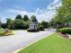 Community entrance with brick walls and metal gate surrounded by green grass and trees at 2630 Milford Ln, Alpharetta, GA 30009