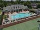 Overhead view of a community pool with furniture and tennis courts at 2630 Milford Ln, Alpharetta, GA 30009