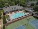 Overhead view of a community pool, pool furniture, and tennis courts at 2630 Milford Ln, Alpharetta, GA 30009
