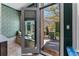 The open glass doors leading to the outdoor living space in the dining area at 2630 Milford Ln, Alpharetta, GA 30009