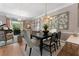 Bright dining room with modern chandelier, hardwood floors, and a grand piano at 2630 Milford Ln, Alpharetta, GA 30009