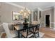 Elegant dining area with hardwood floors, sophisticated lighting, and open floor plan at 2630 Milford Ln, Alpharetta, GA 30009