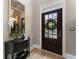 Inviting foyer featuring a dark wood door with decorative wreath and stylish console table at 2630 Milford Ln, Alpharetta, GA 30009