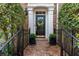 Charming brick entryway leads to a black front door with decorative wreath and manicured landscaping at 2630 Milford Ln, Alpharetta, GA 30009