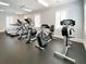 The gym contains treadmills, elliptical machines, stationary bikes, and windows with blinds at 2630 Milford Ln, Alpharetta, GA 30009