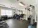 A well-equipped gym features weights, a cable machine, mirrors, and plenty of natural light at 2630 Milford Ln, Alpharetta, GA 30009