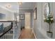 Hallway showcasing hardwood floors, modern lighting, and access to a bathroom at 2630 Milford Ln, Alpharetta, GA 30009
