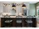 A stunning kitchen featuring a spacious island with bar seating, stainless appliances, and stylish pendant lighting at 2630 Milford Ln, Alpharetta, GA 30009