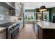 Gourmet kitchen features stainless steel appliances, custom cabinetry, and a large center island with bar seating at 2630 Milford Ln, Alpharetta, GA 30009