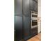 Dark cabinets with stainless steel oven, microwave, and gold handles in the kitchen at 2630 Milford Ln, Alpharetta, GA 30009