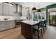 Bright kitchen with stainless appliances, an island with bar seating, and an adjacent outdoor patio at 2630 Milford Ln, Alpharetta, GA 30009