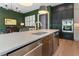 Kitchen island with a sink, stainless steel dishwasher, and views of the green wall at 2630 Milford Ln, Alpharetta, GA 30009