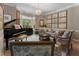 Comfortable living room with a grand piano, bay window, chandelier, and stylish decor at 2630 Milford Ln, Alpharetta, GA 30009
