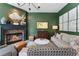 Charming living room with fireplace, green walls, hardwood floors, and stylish decor at 2630 Milford Ln, Alpharetta, GA 30009
